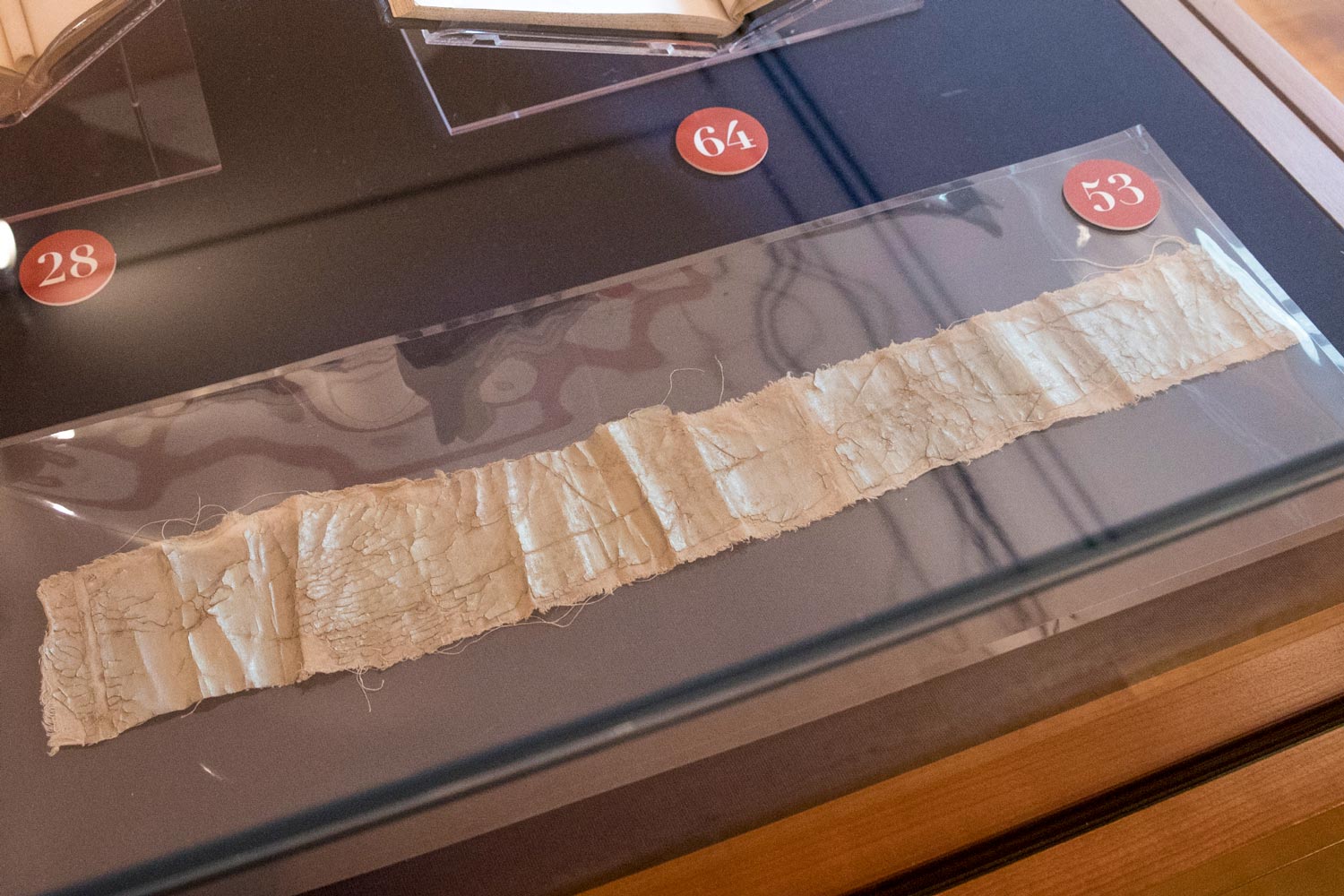 A strip of old fabric in a display case