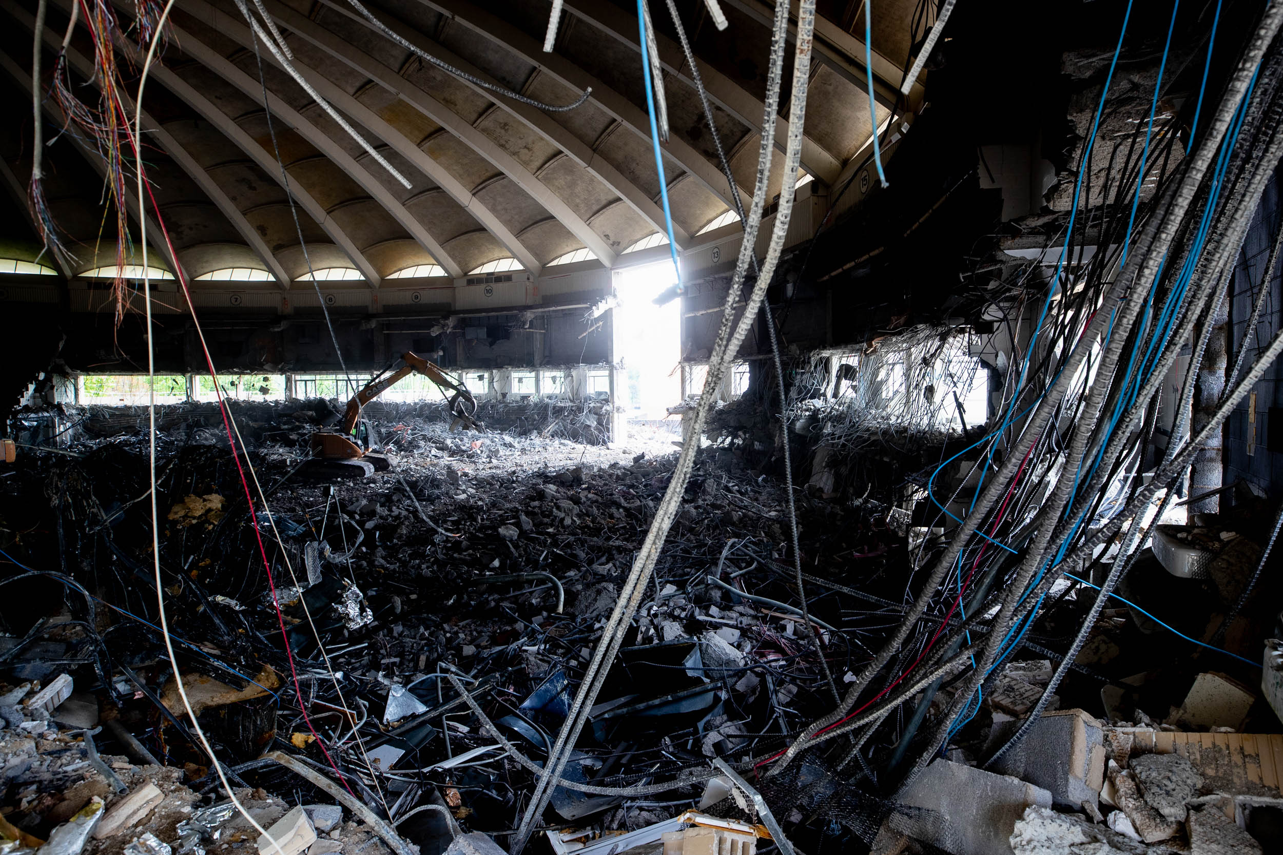 Inside demolition of UHall with wires hanging from the ceiling and walls