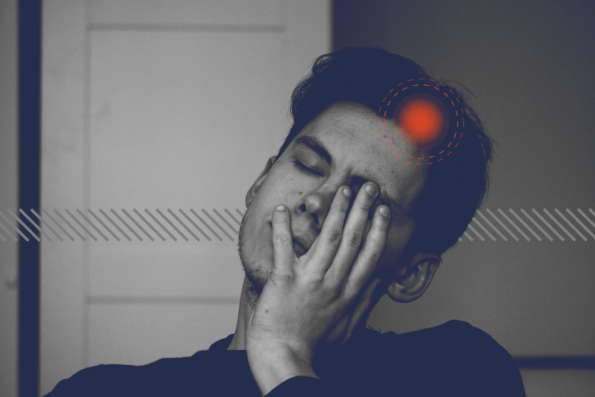 A man leans his face on his hand in apparent pain. A red dot on his head signaling pain.