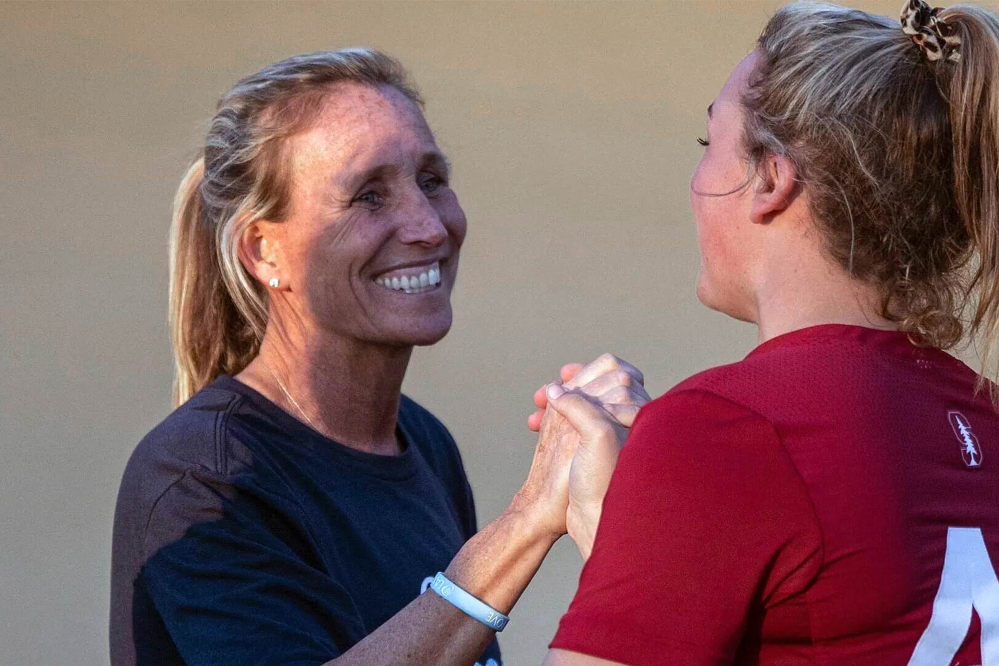 Julie Myers locked in a handshake of one of her players