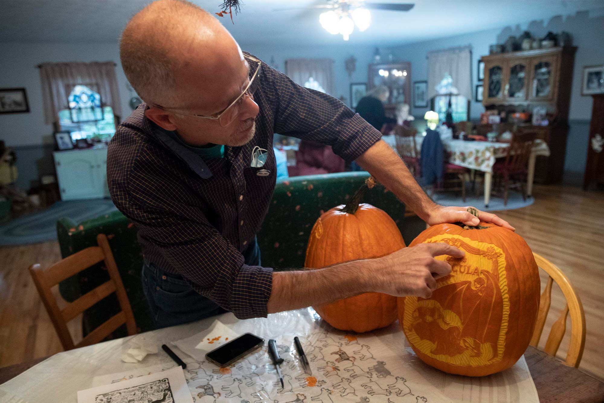 Ed Morton Caring a pumpkin in his kitchen