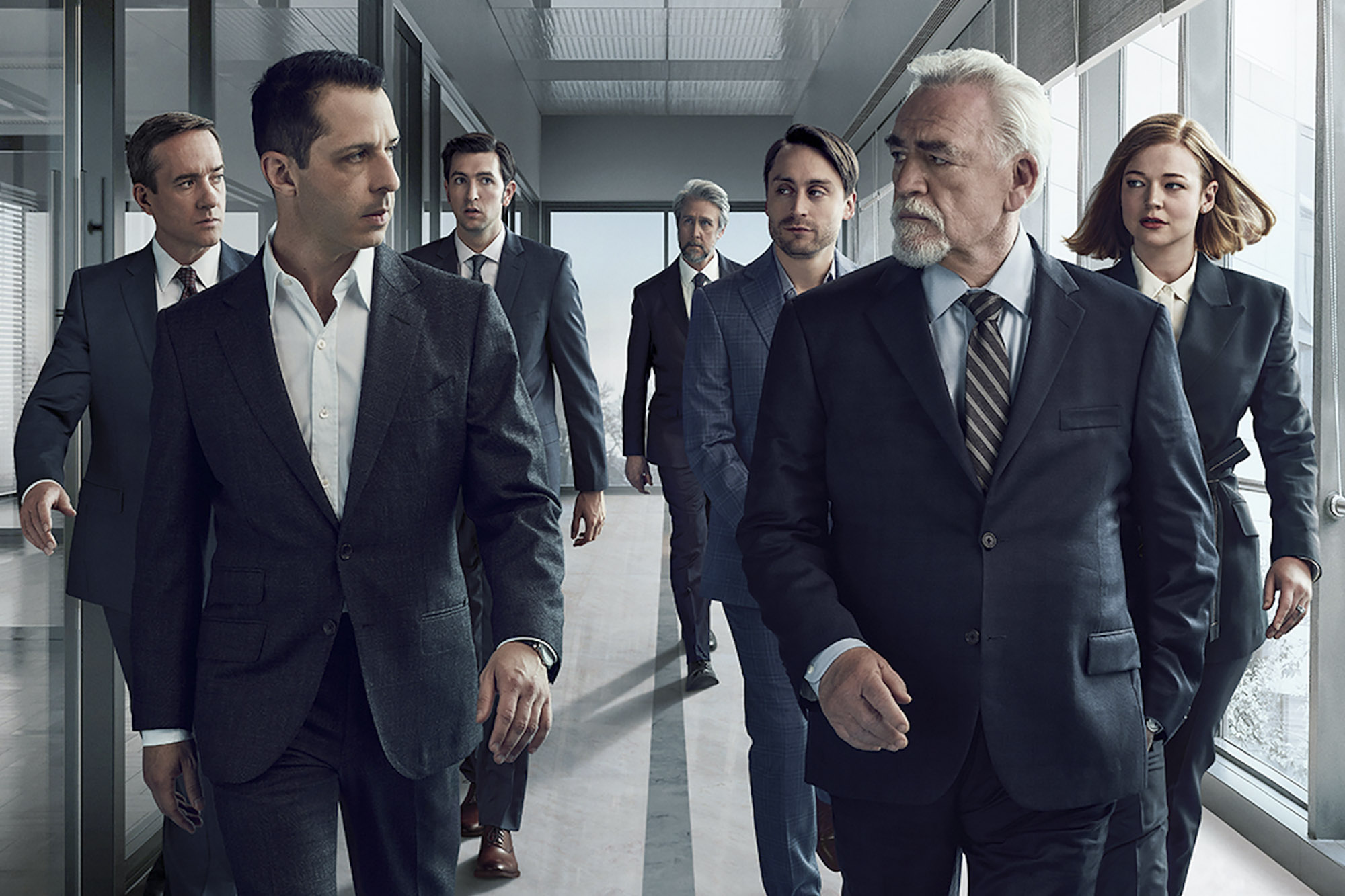 Group of business people walking down a hallway with upset looks on their faces and overly gray shadowing/coloring