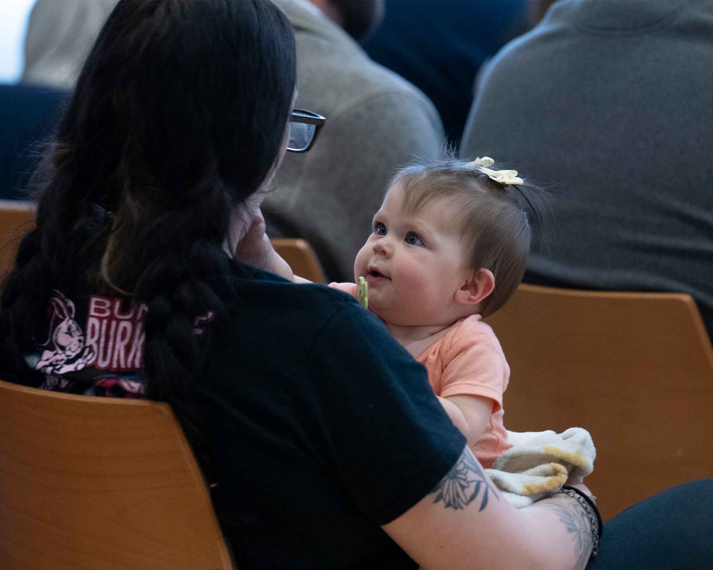Baby stares at mom during graduation