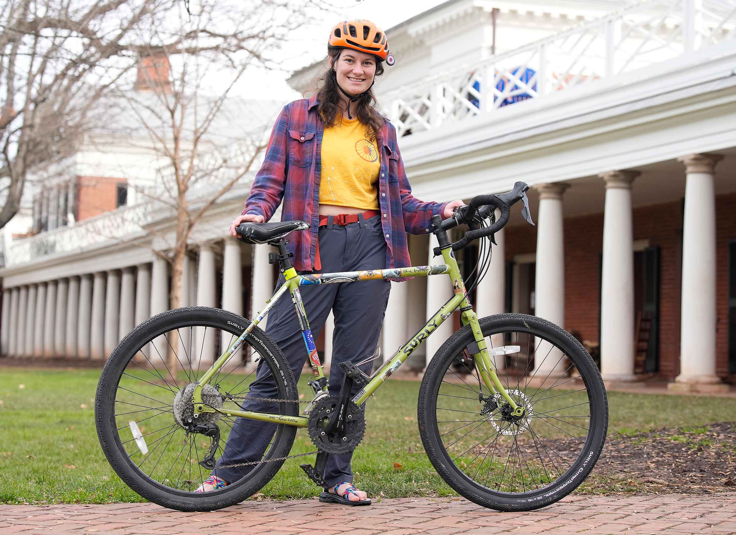 Portrait of Elli Welch with their bike on the Lawn