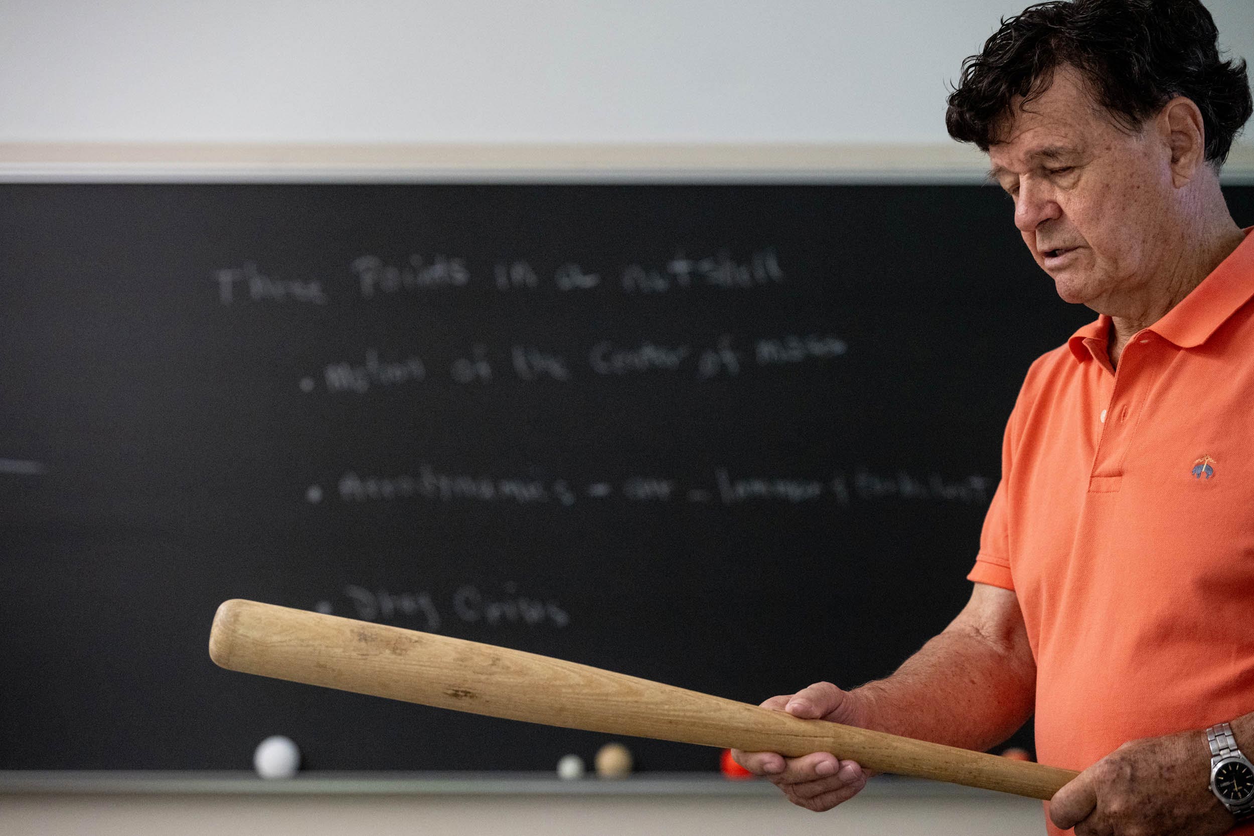 Professor holds baseball bat