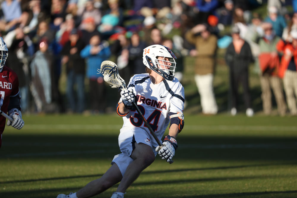 Action lacrosse shot with player holding ball in net