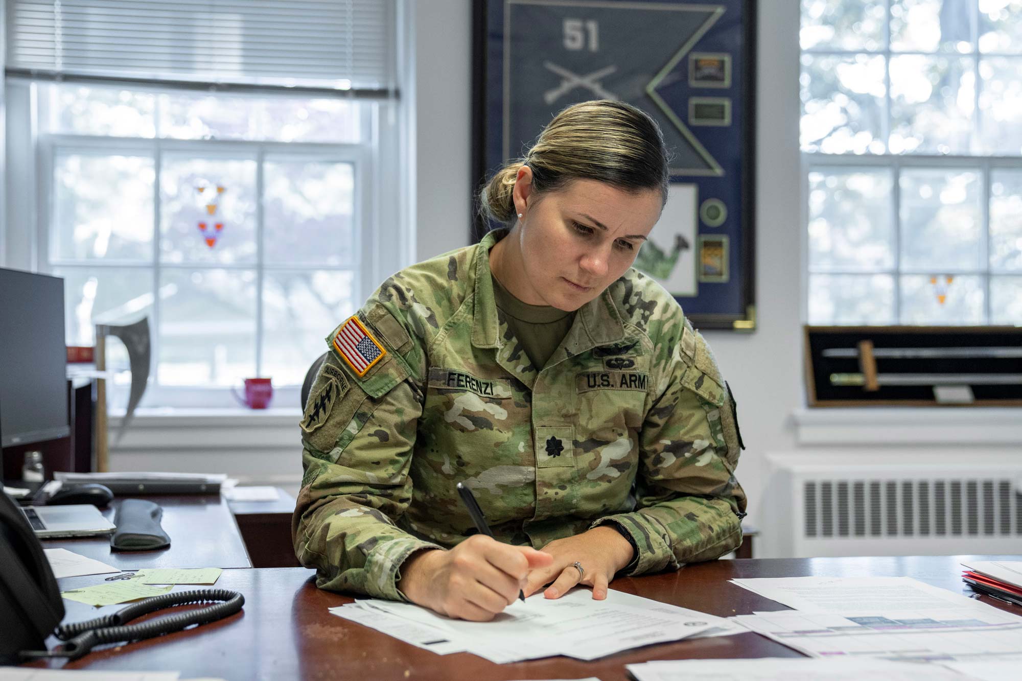 Portait of Lieutenant Colonel Elizabeth Eaton-Ferenzi working at her desk in her office