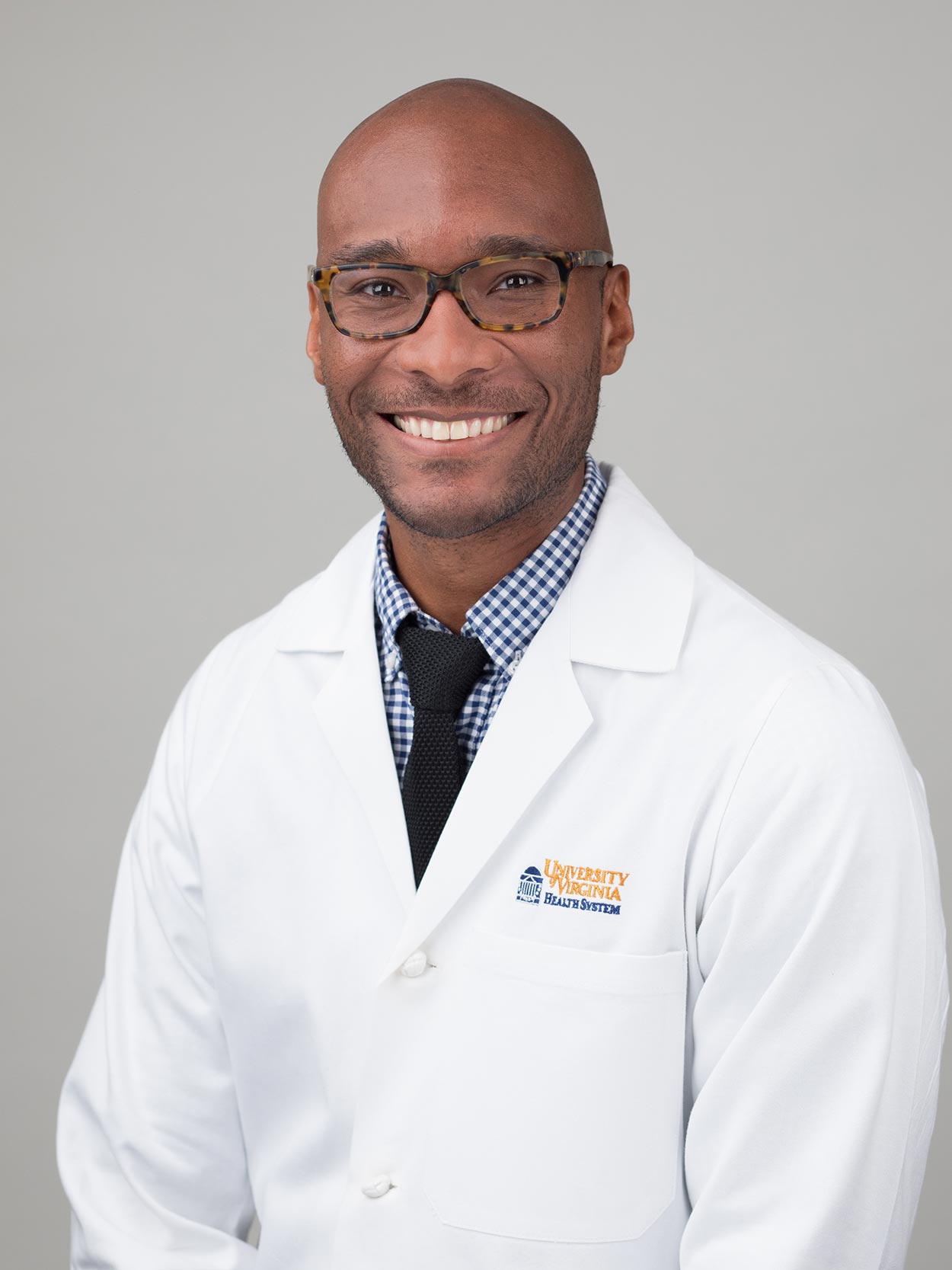 UVA Health's Dr. Taison Bell in a white coat and tie