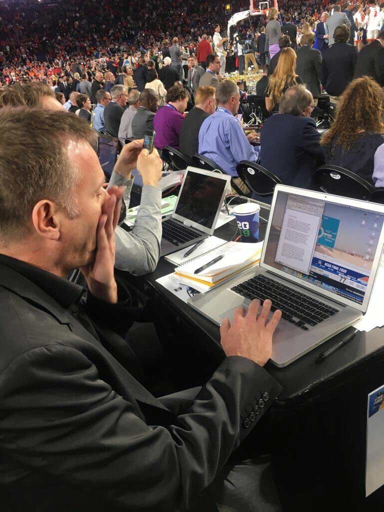 Over Chuck Culpepper's shoulder of him looking at a laptop