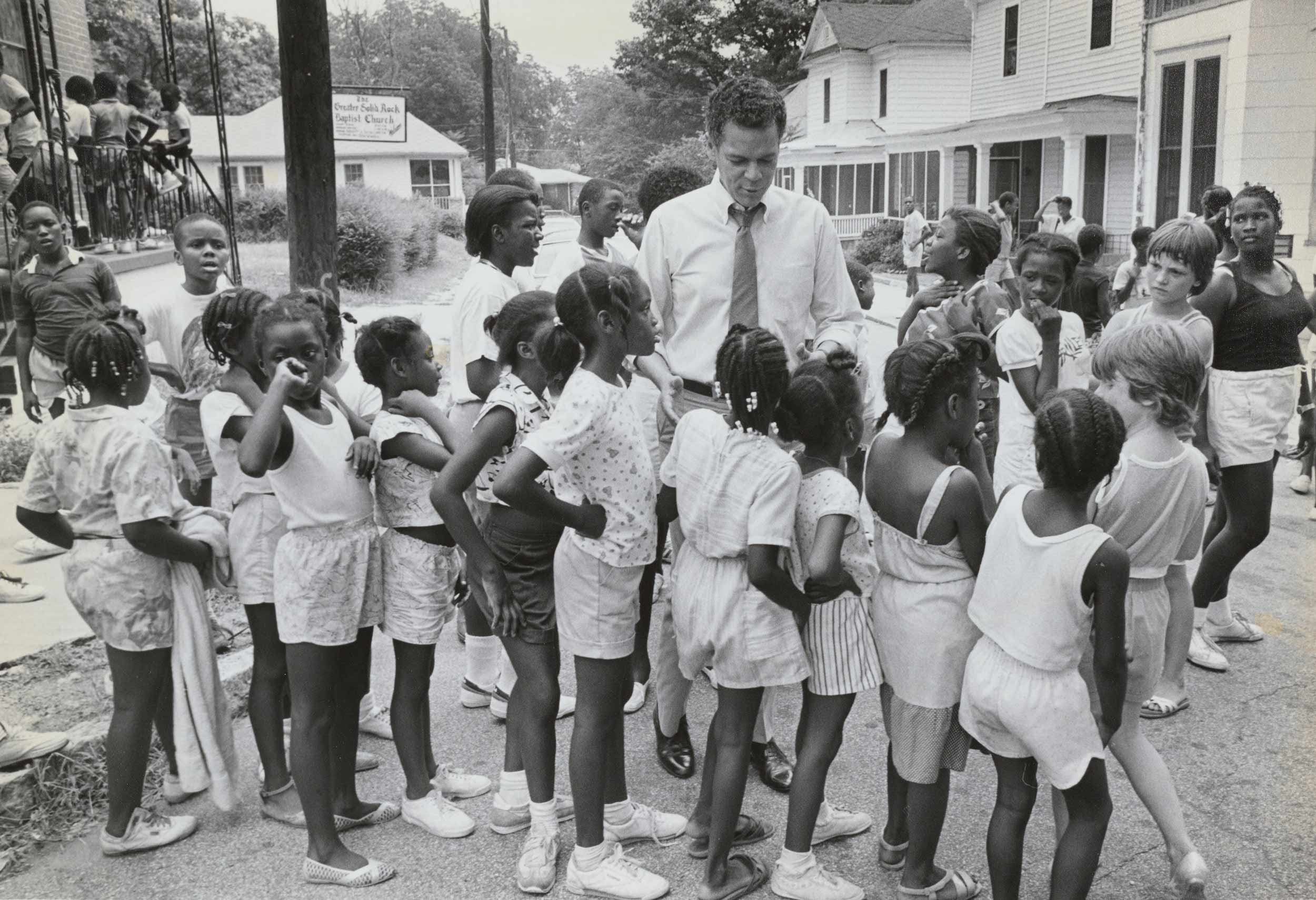 Julian Bond when he was a student activist surrounded by children