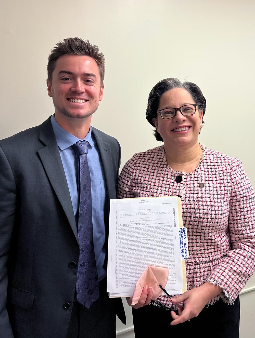 Nate Wunderli poses with Jennifer McClellan who is holding a document