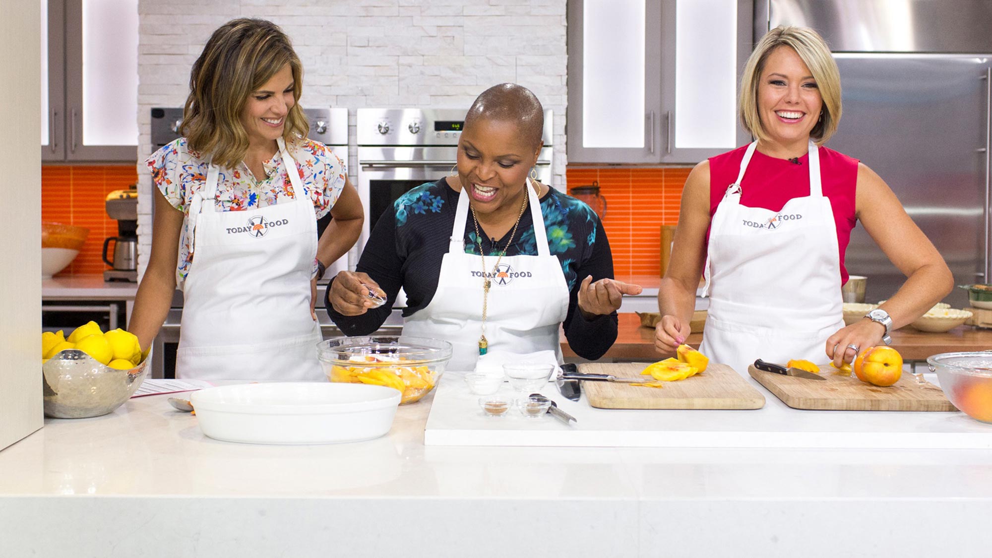 Photo of Tanya Holland with two hosts of NBC's "Today" show preparing a dish with peaches
