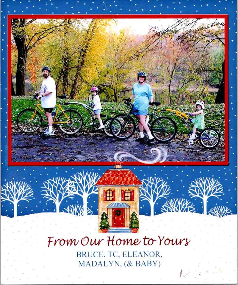 An old Welch family Christmas card including a photo of all four family members and their bikes
