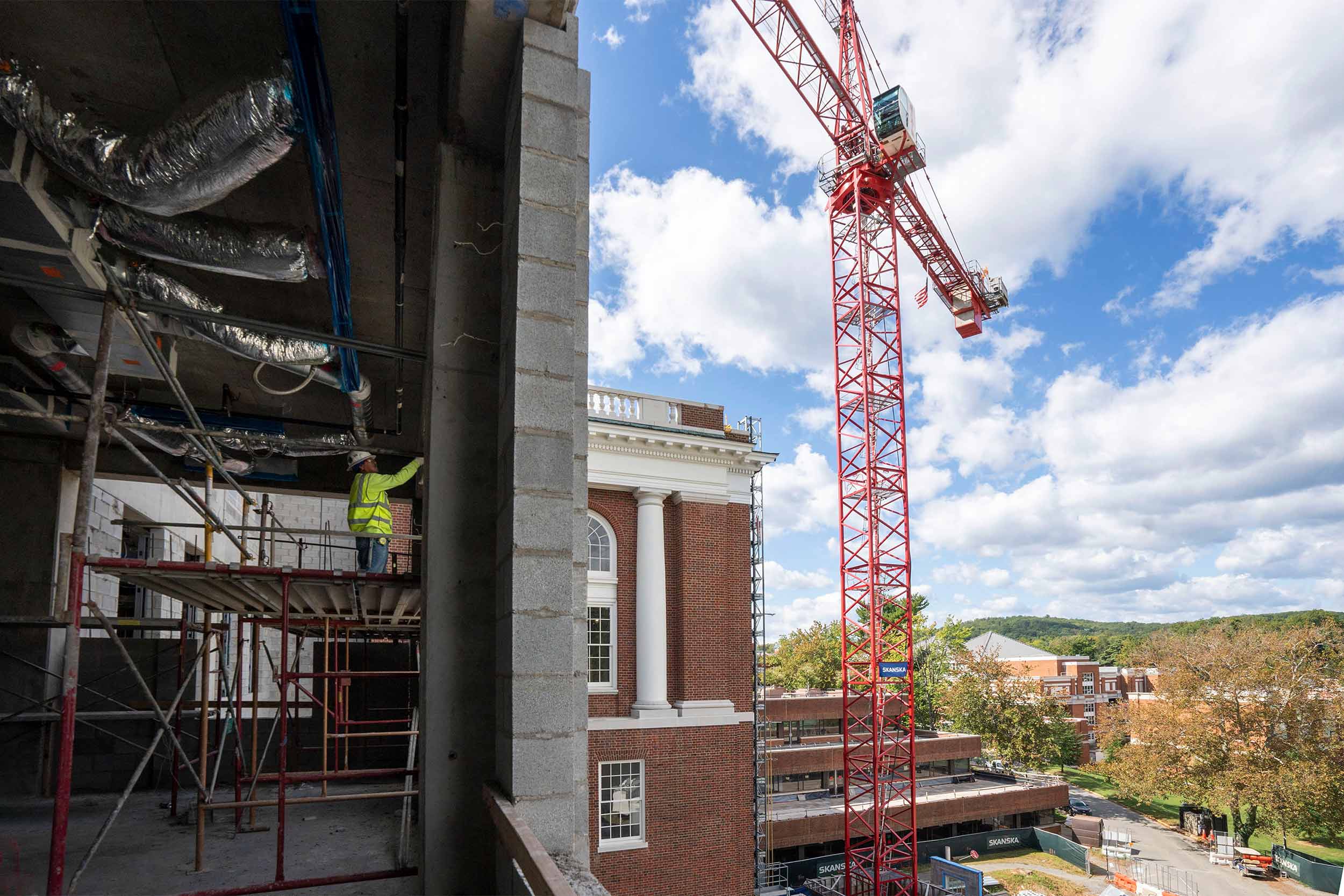Construction crews working on the inside of Alderman library while a crane sits high outside