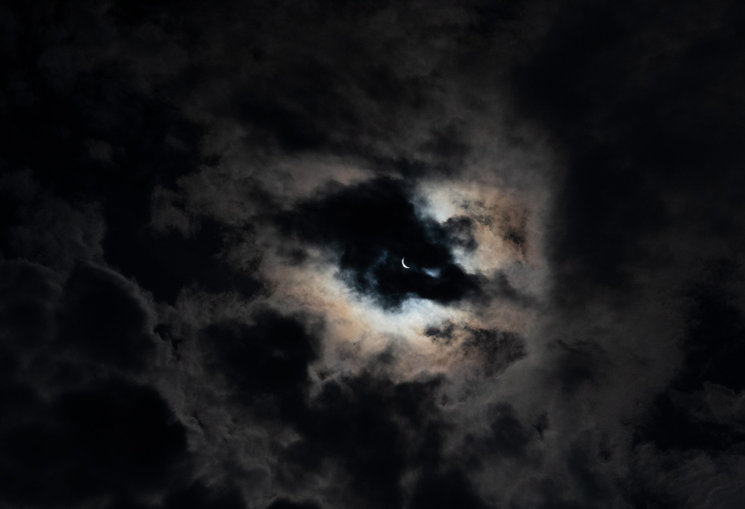 Clouds share a view of the eclipse at peak