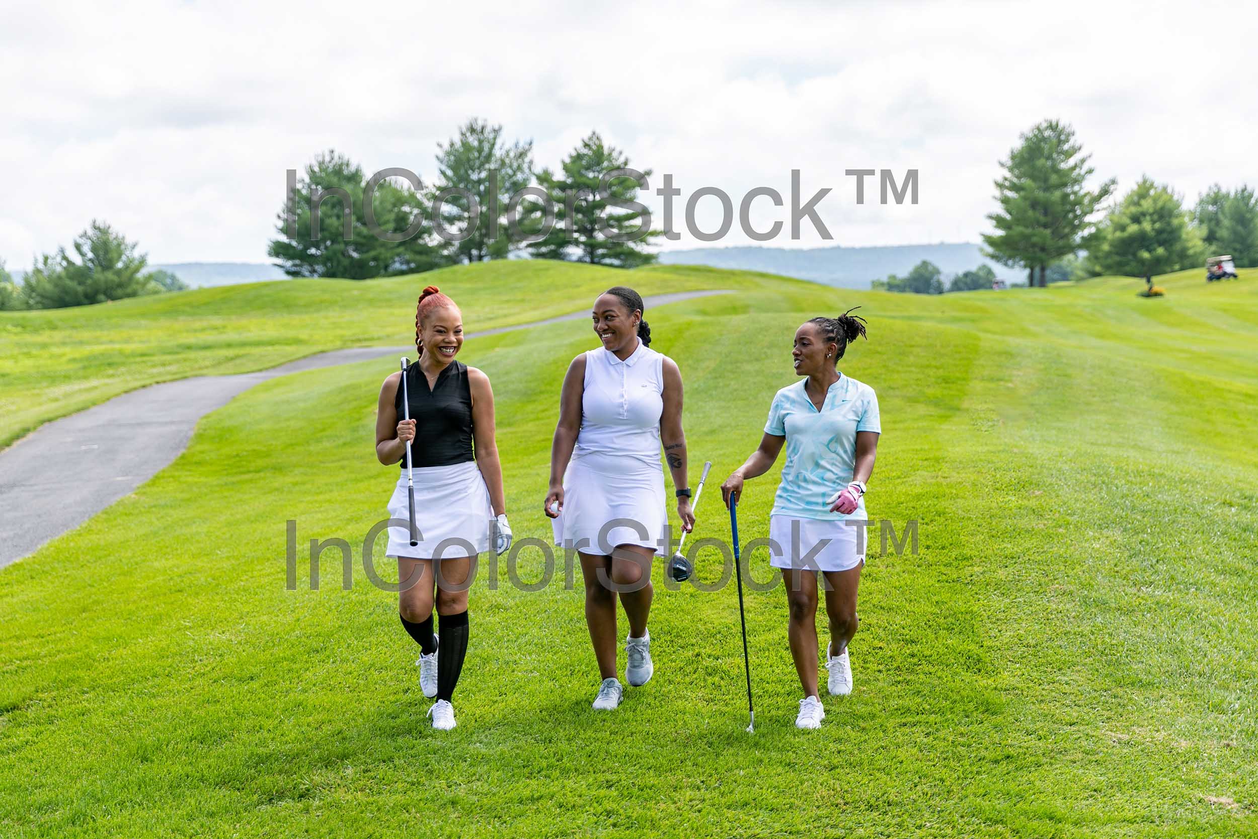 Three women golfing