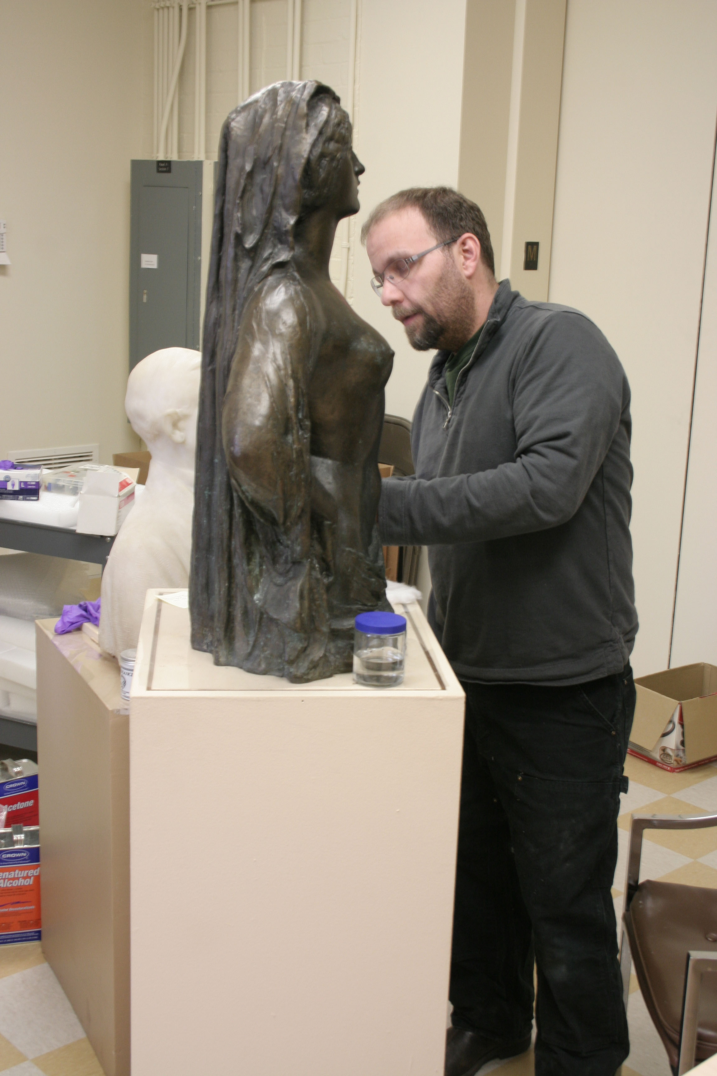 Adam Jenkins working on a bust statue