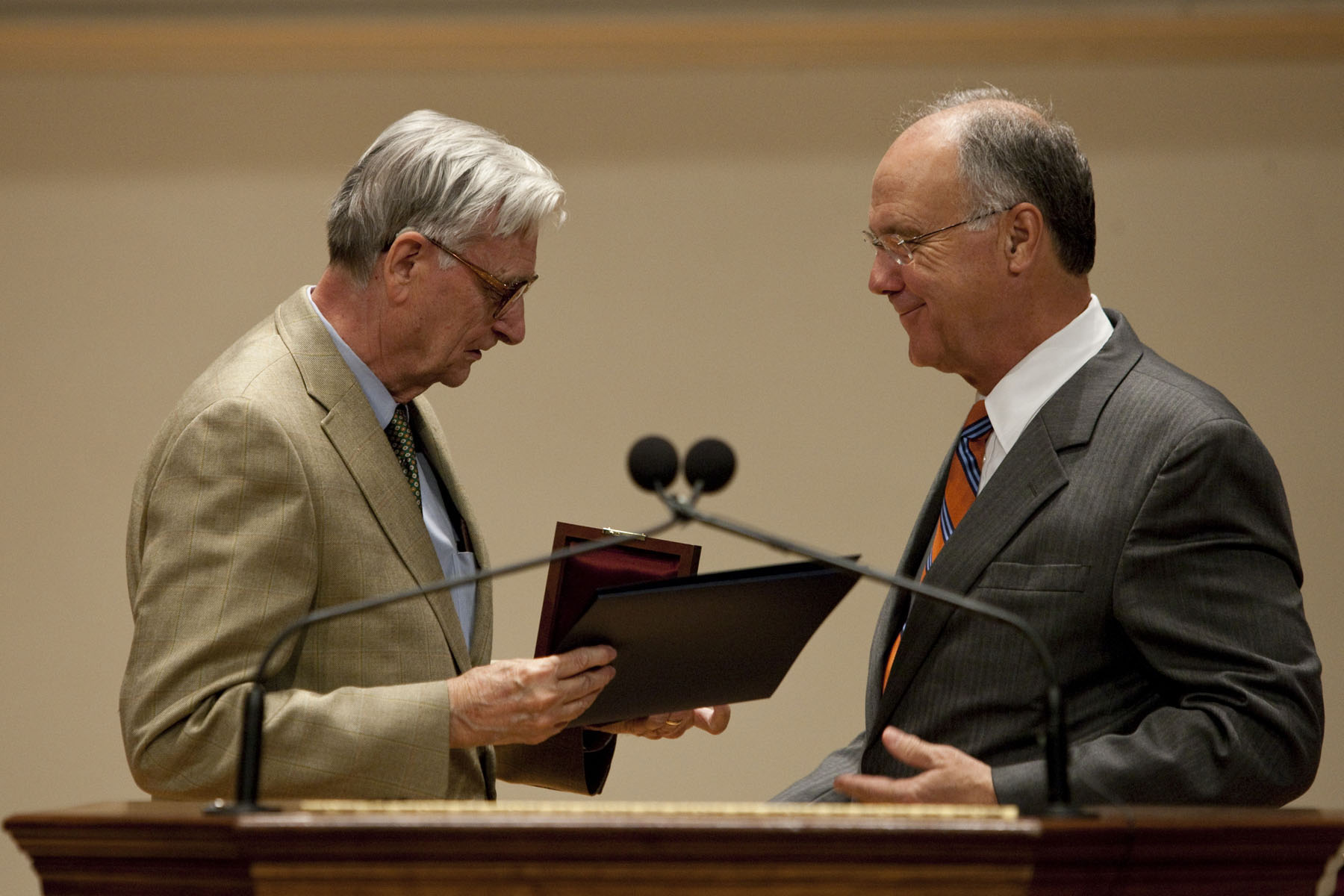 Edward O. Wilson hands a certificate and a plaque to  President John T. Casteen III