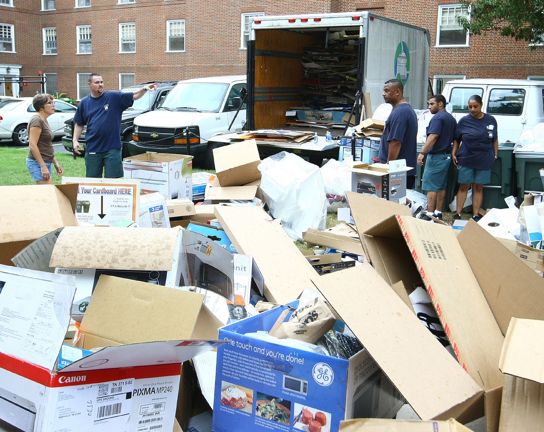 Piles of cardboard boxes being recycled outside of a dorm on move-in day