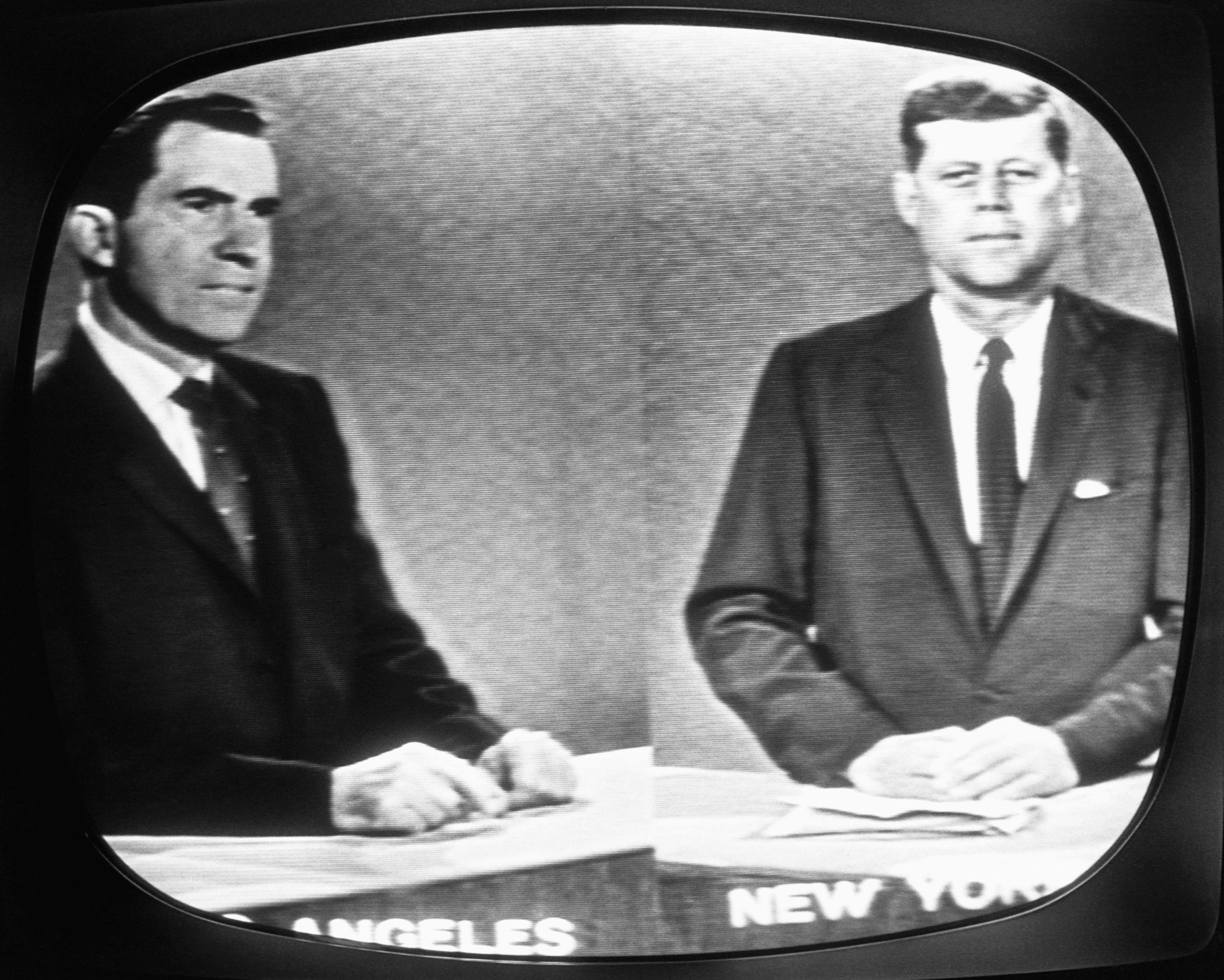 Kennedy, right, and Nixon, left, standing at podiums during a televised debate