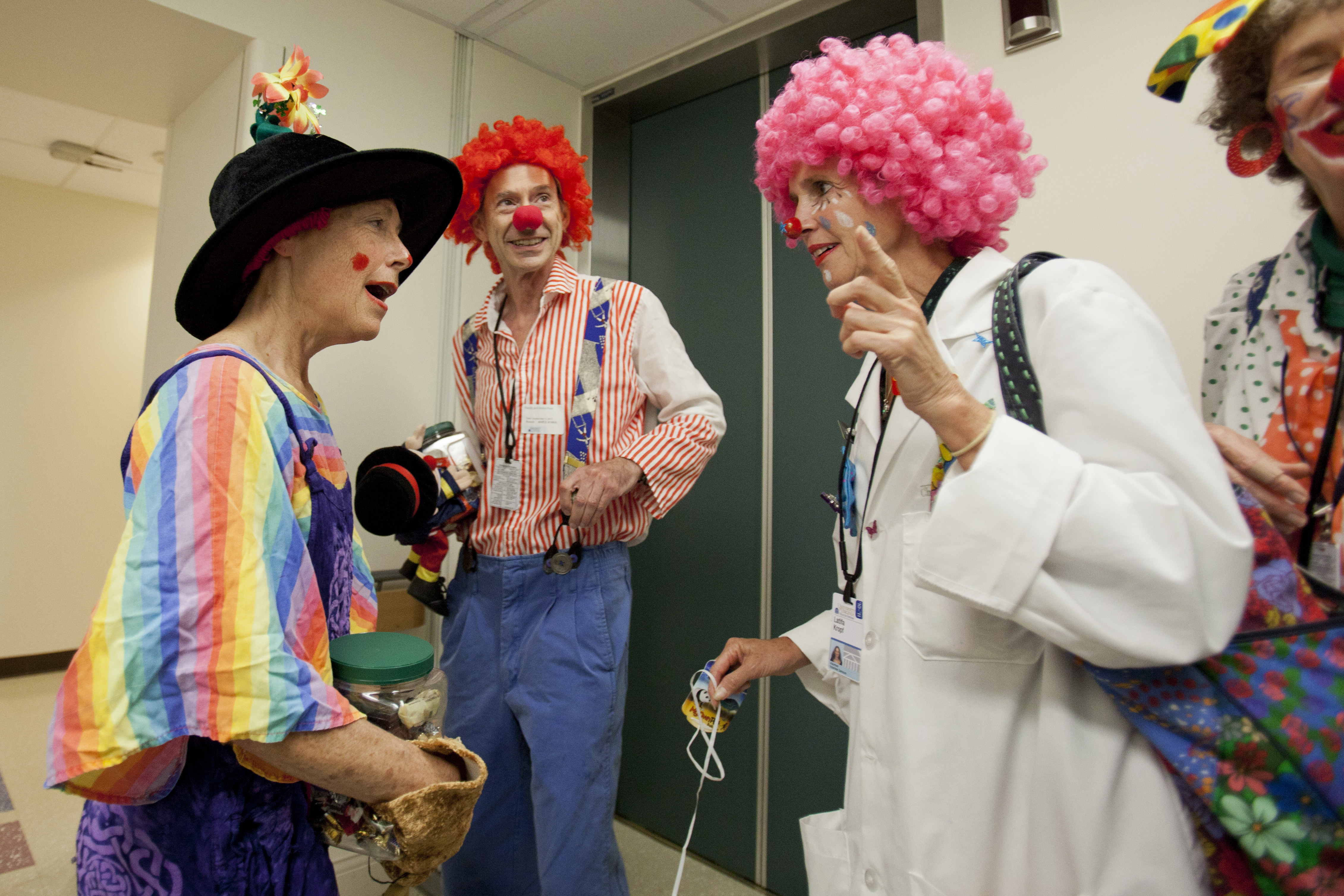 People dressed up as clowns talk in the hallway of the UVA Hospital