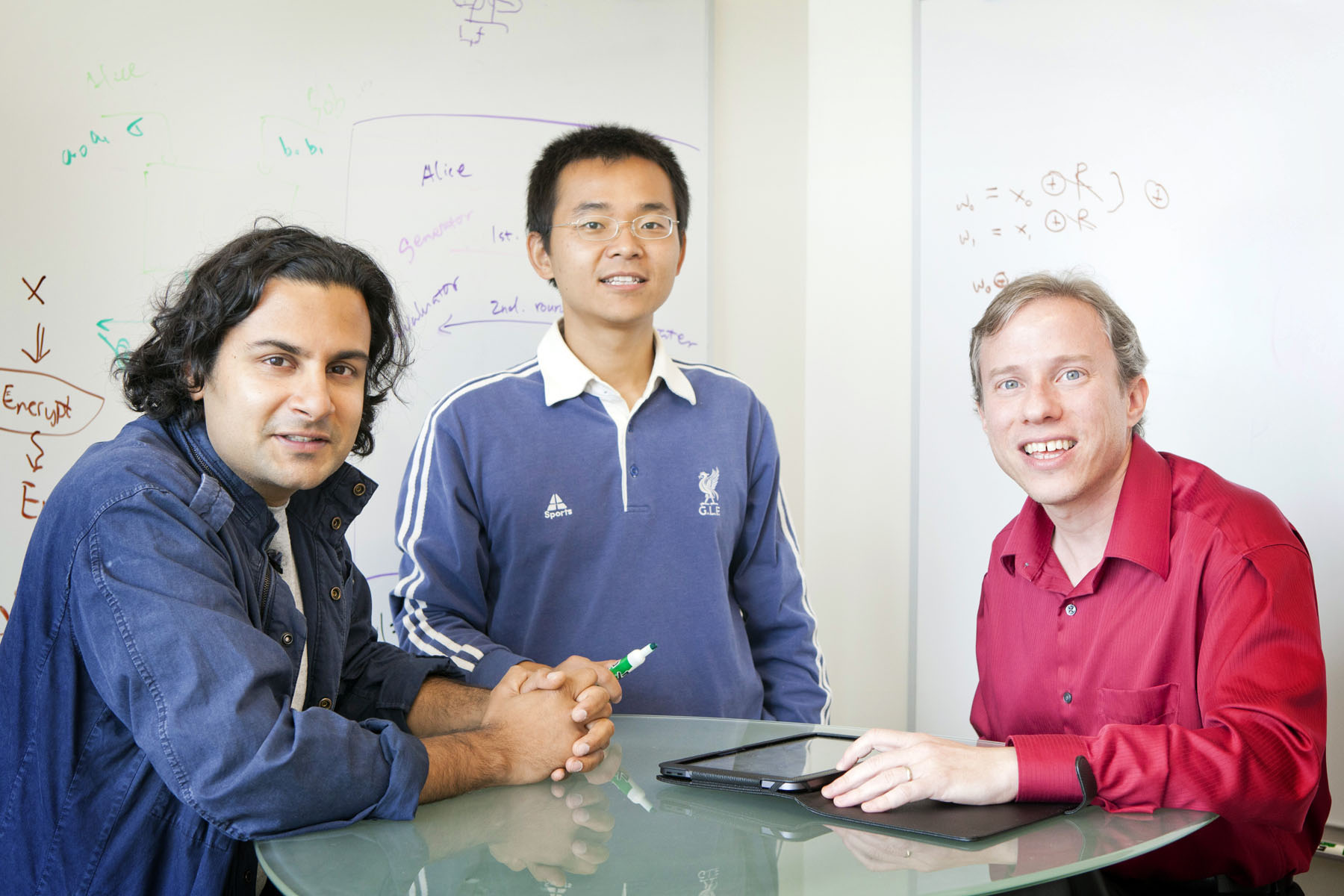 Three people working together. Left to right: abhi shelat, Yan Huang, and David Evans