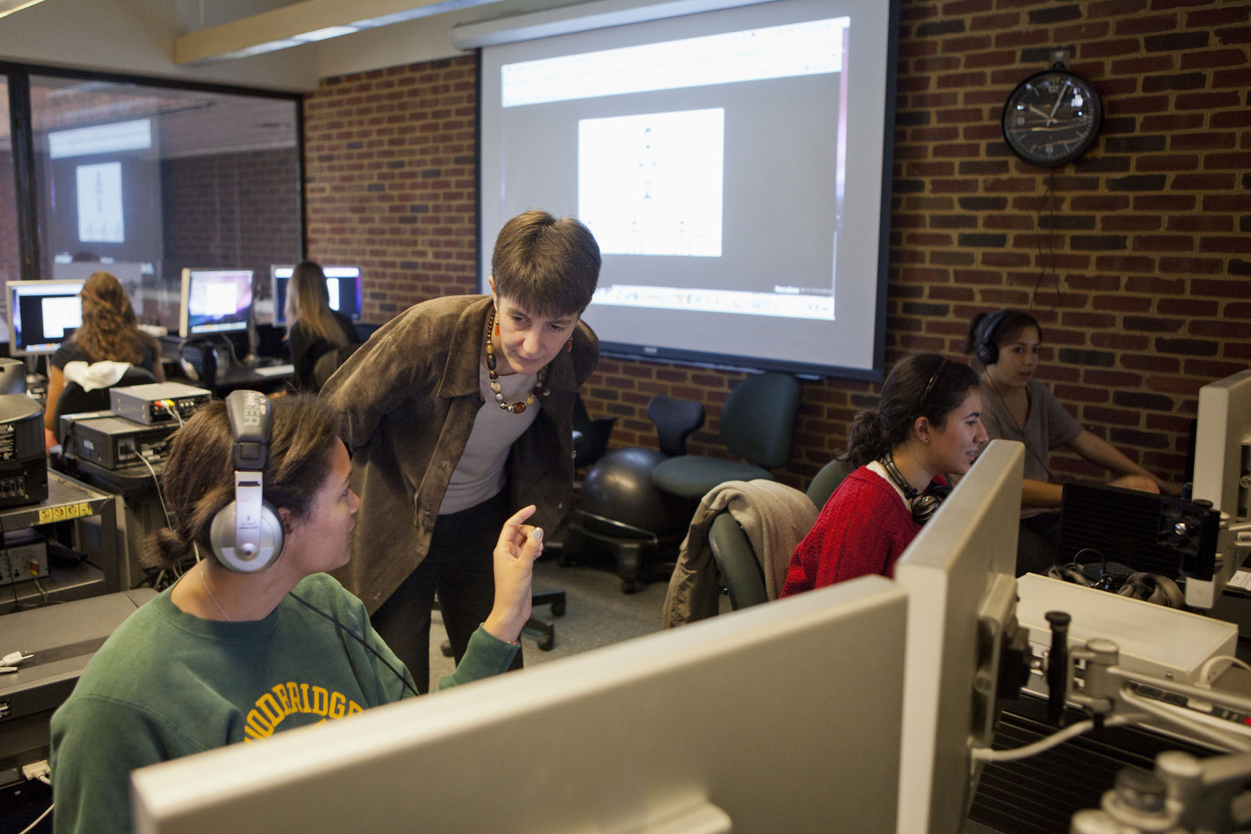 Alison Levine talks to a student working on a computer