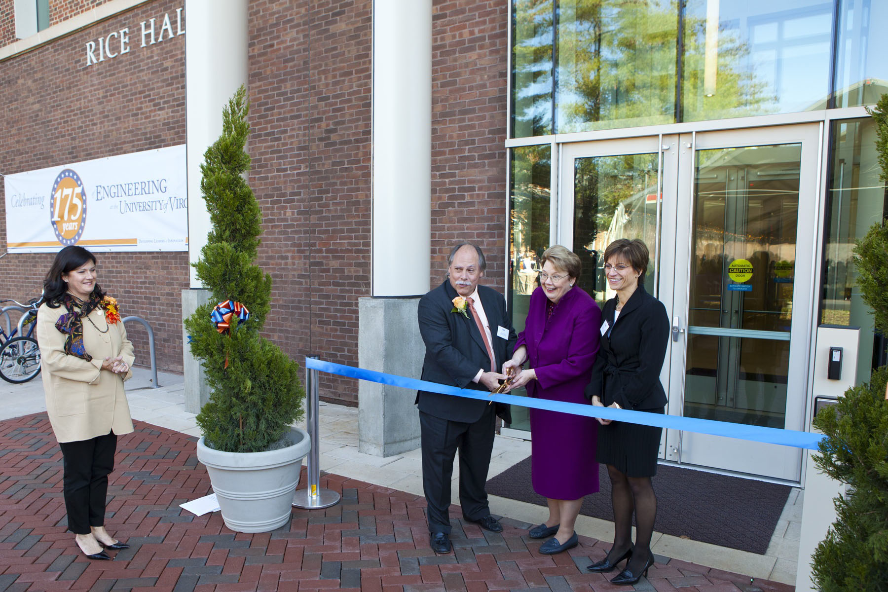 Paul Rice, U.Va. President Teresa A. Sullivan and Rector Helen E. Dragas cutting a ribbon in front of Rice Hall