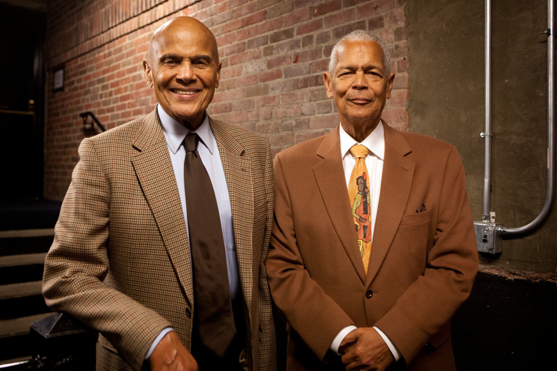  Harry Belafonte, left, and Julian Bond, right, stand together smiling at the camera