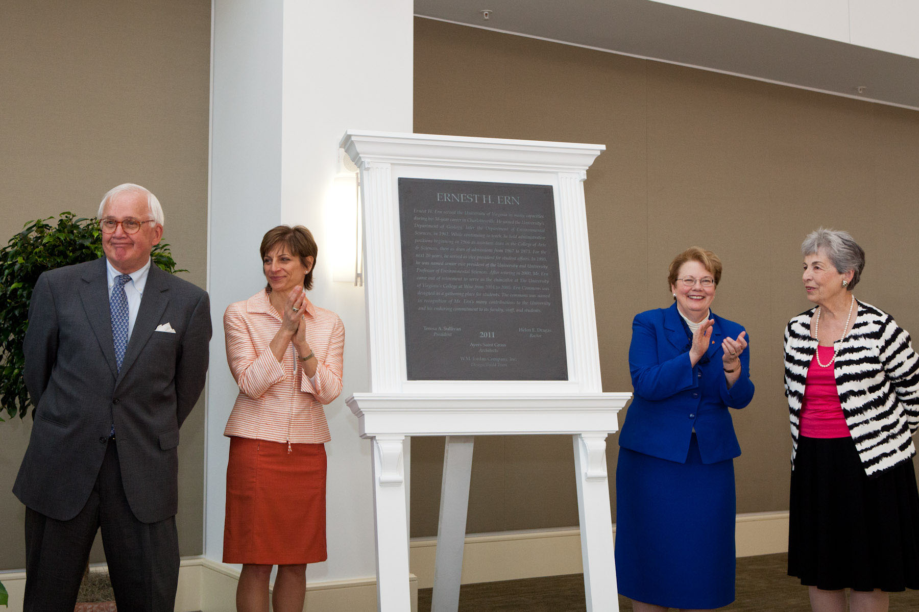 Ernest H. Ern, left, stands as a plaque is revealed in his honor.  