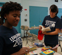 Chelsea Stokes (left) and Mary Kidd sorting books