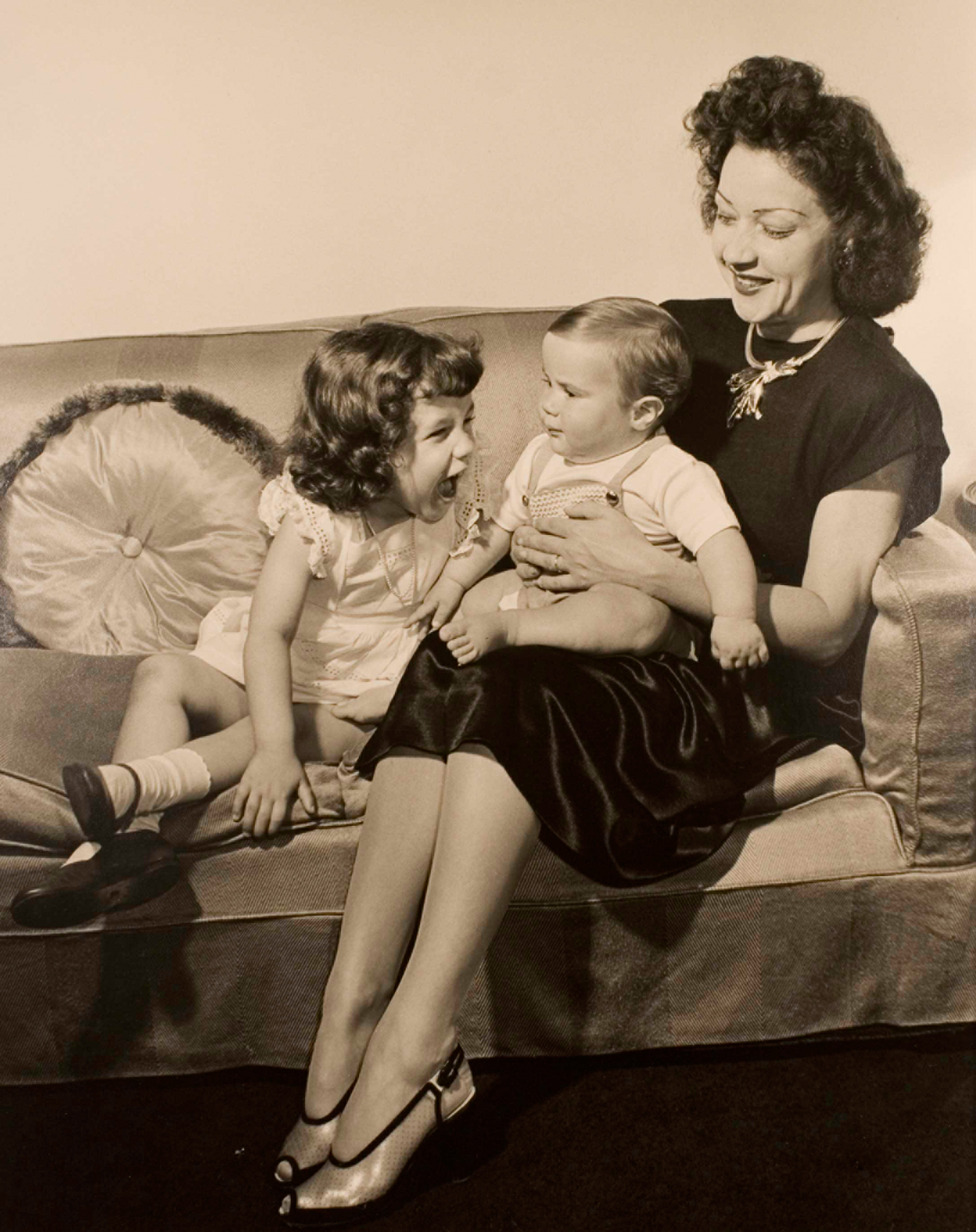 Philippe Halsman holds her two children on a couch