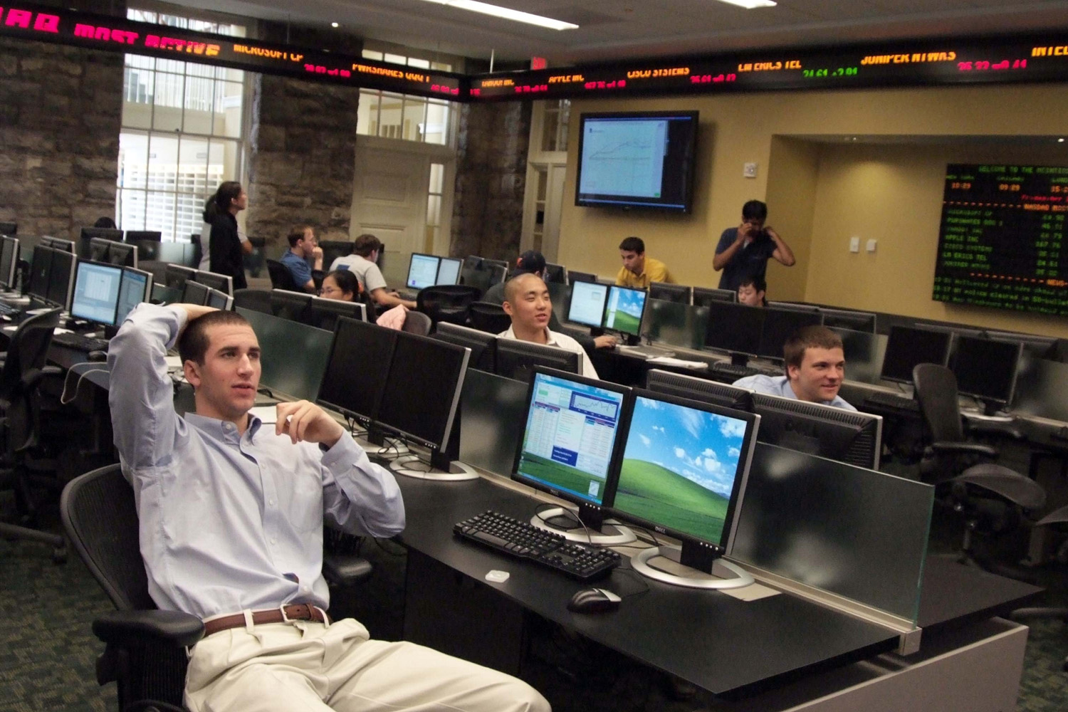 Andrew Cook, Sihyun Choi, and Chris Miller watch the stock market