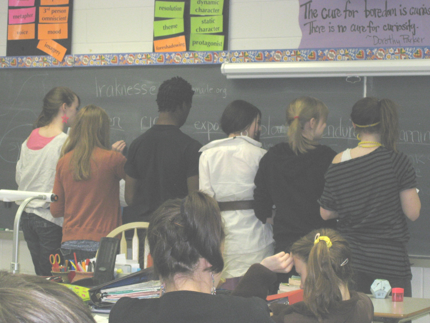 Middle School Students writing on a chalkboard