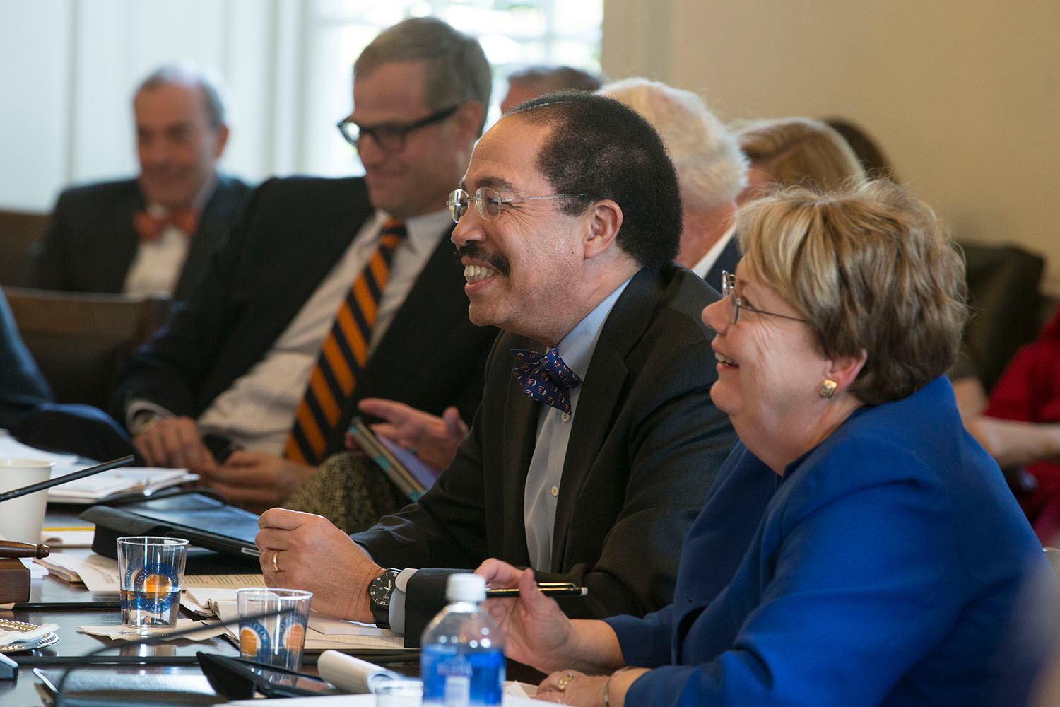 President Teresa A. Sullivan and Rector George Keith Martin smile while they listen