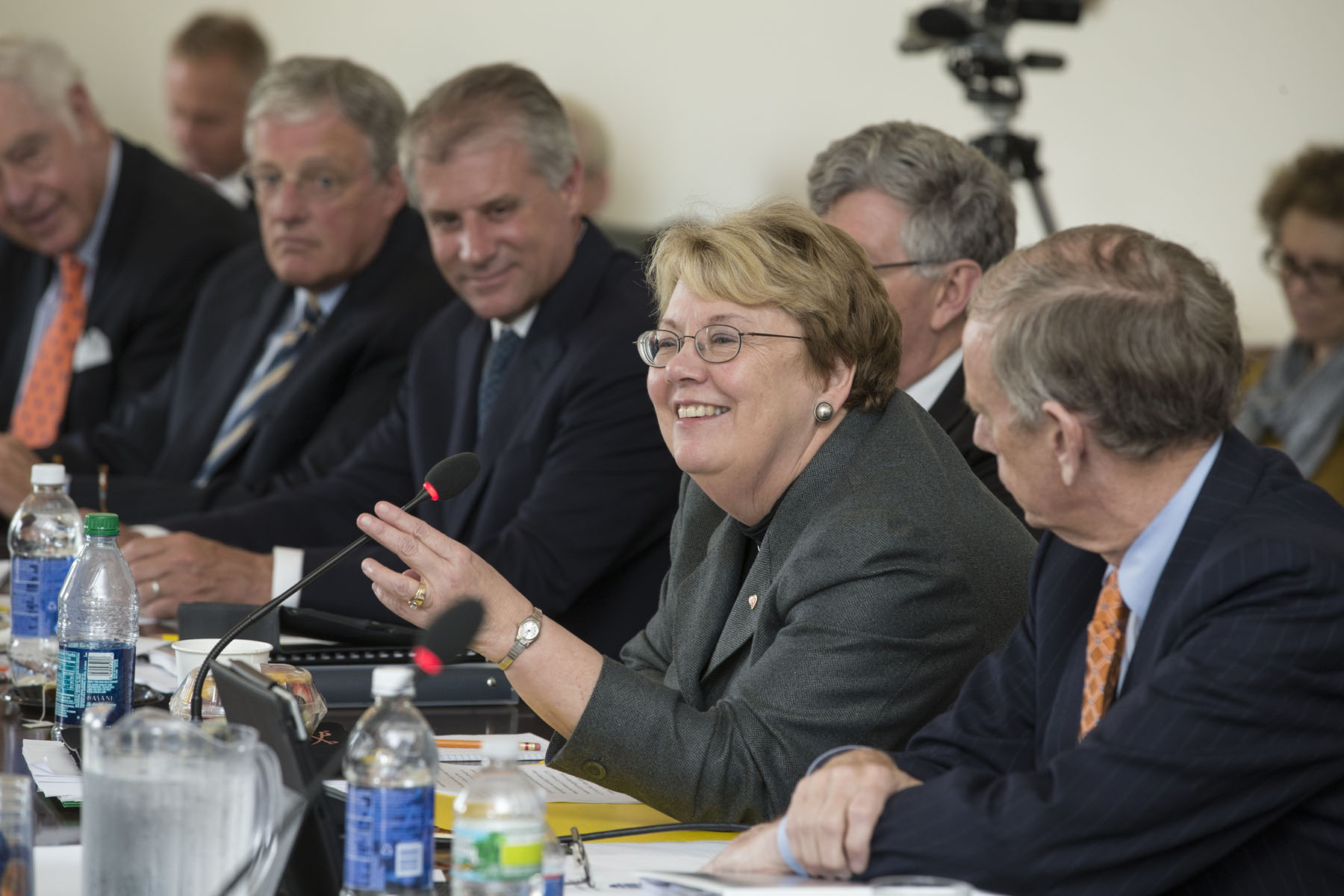 President Teresa Sullivan speaking into a microphone at a Board of Vistors meeting