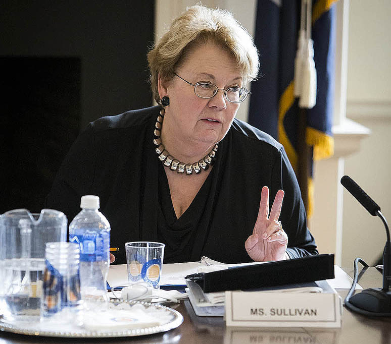 President Teresa A. Sullivan speaking from a table
