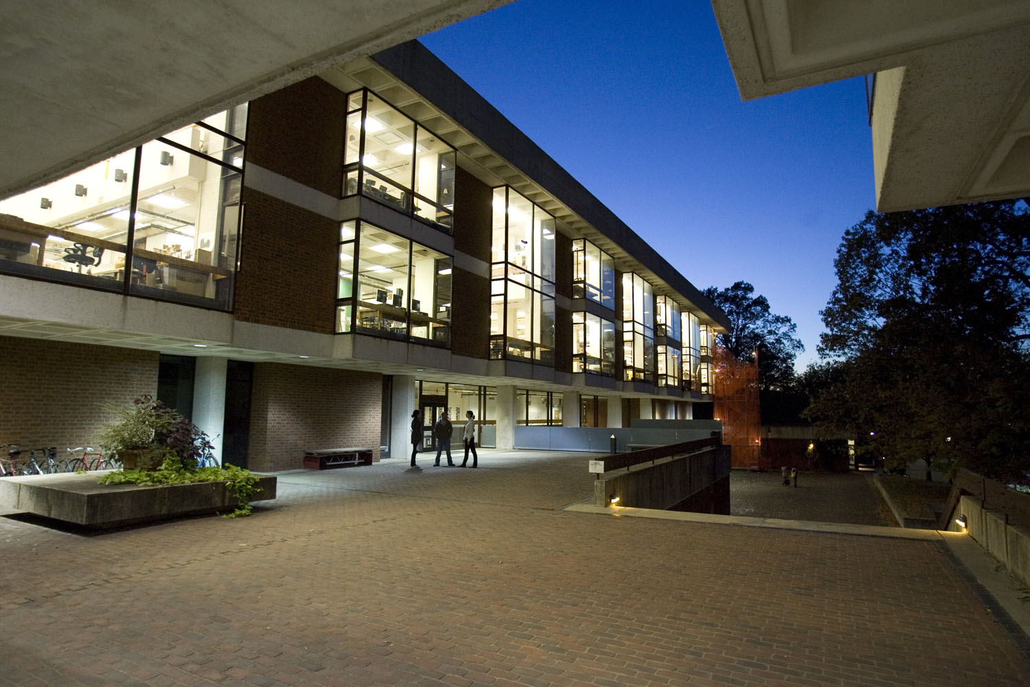Campbell Hall at dusk with the lights shining through the windows