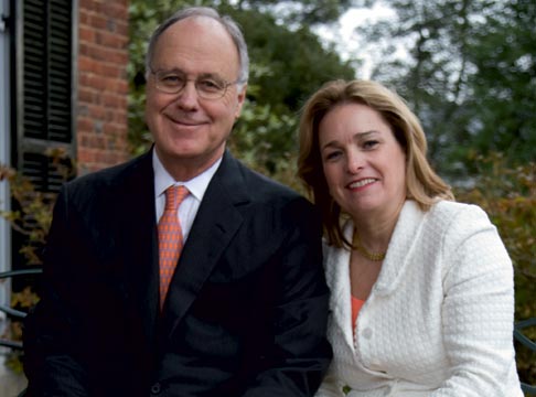 John T. Casteen III and Betsy Casteen smile at the camera as they stand next to each other