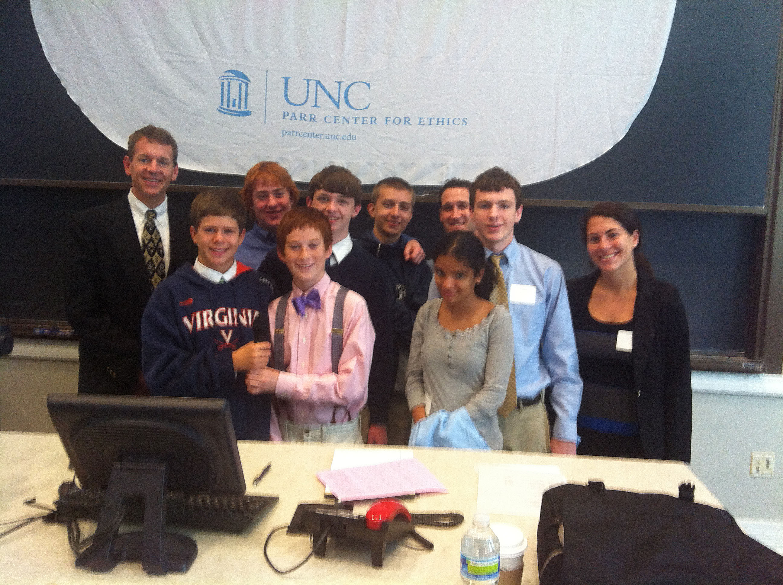 Tory Klein poses with middle school students at an ethics competition