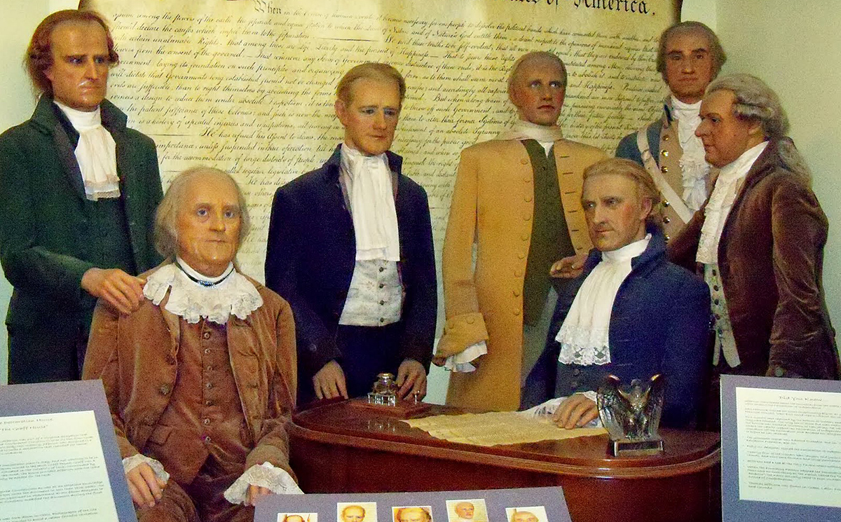 Founding father wax statues at a table