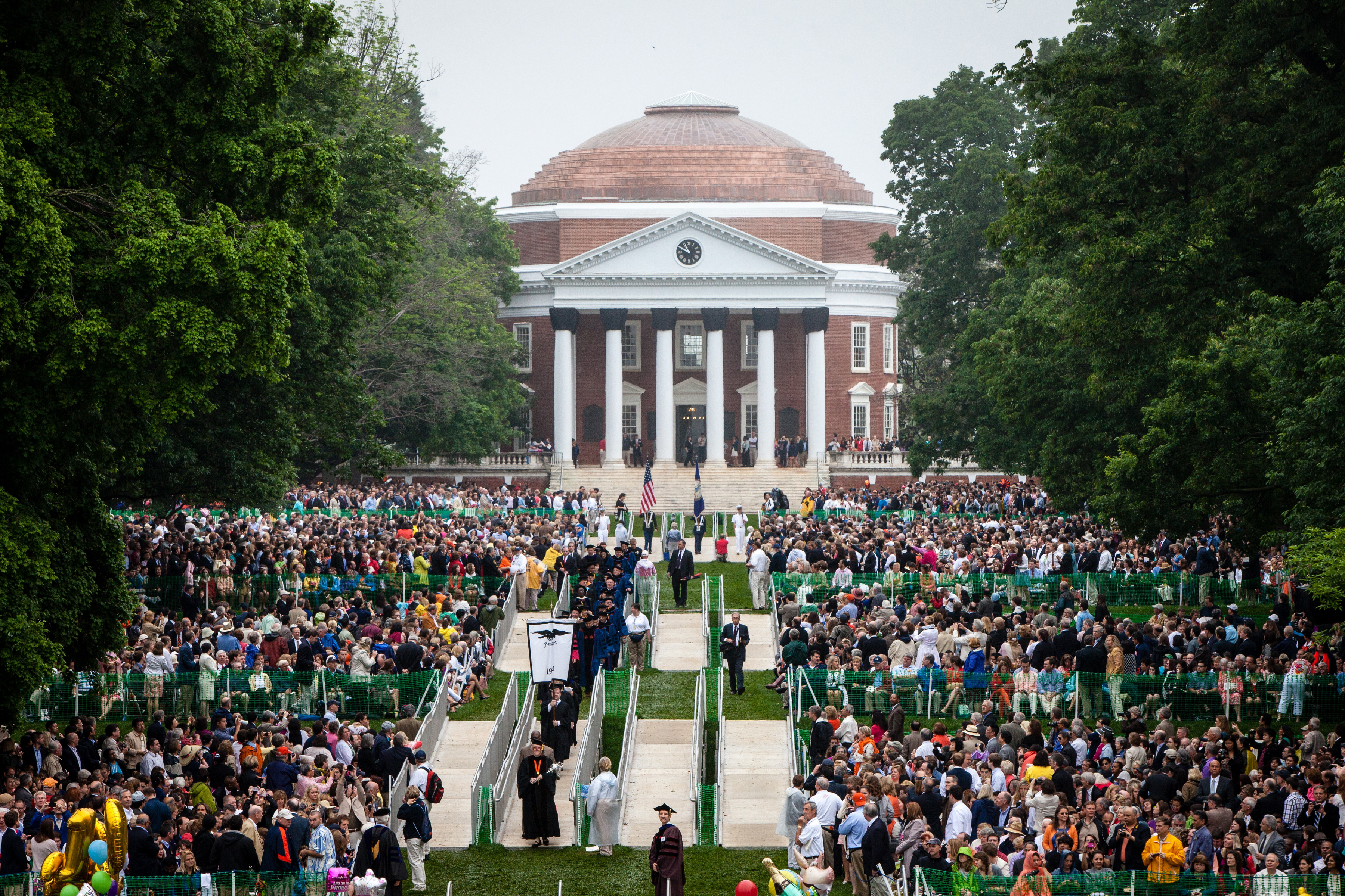 Graduates walking across the lawn from the Rotunda to their seats