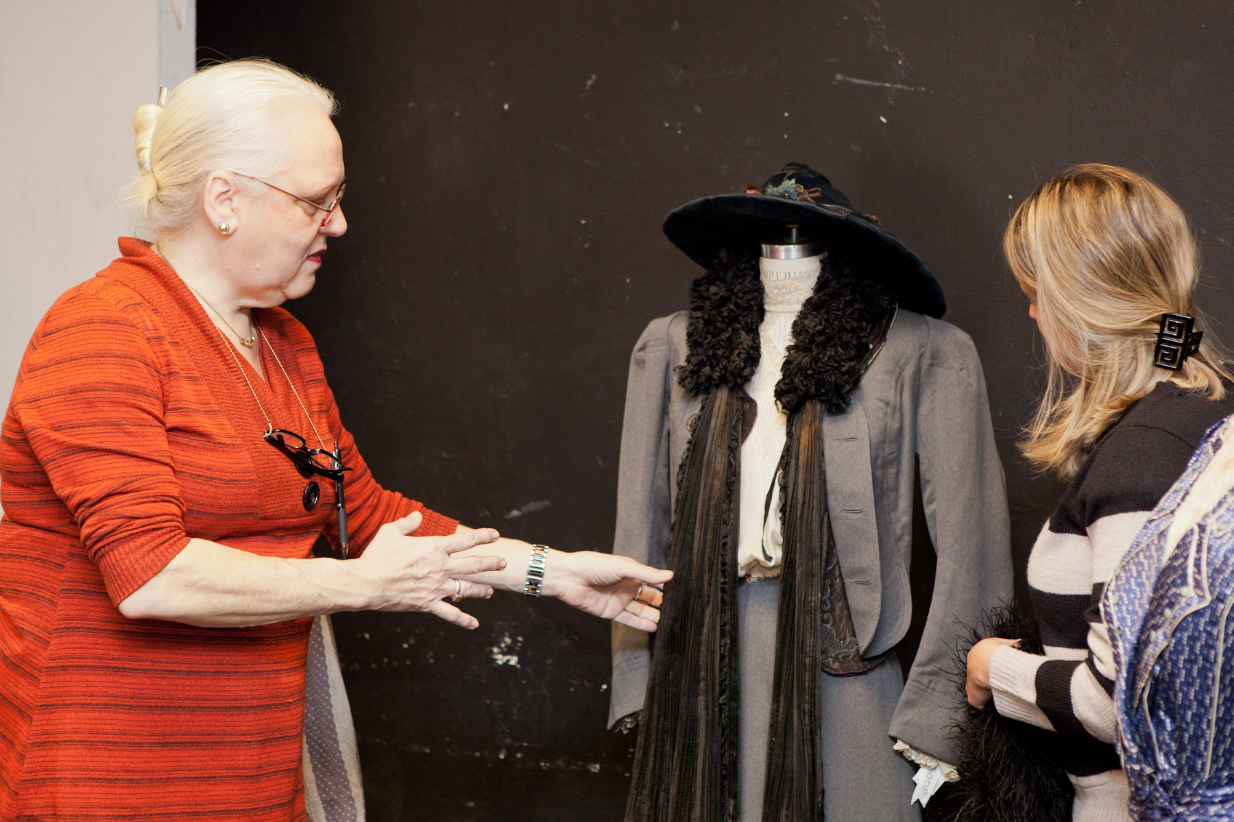 Professor Gweneth West  talks to her class about a woman outfit that she has in the classroom