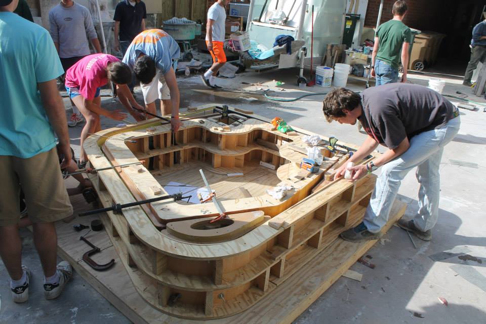 Students working together to build a wooden prototype