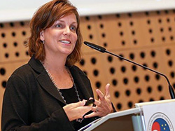 Lisa Stewart speaking at a podium