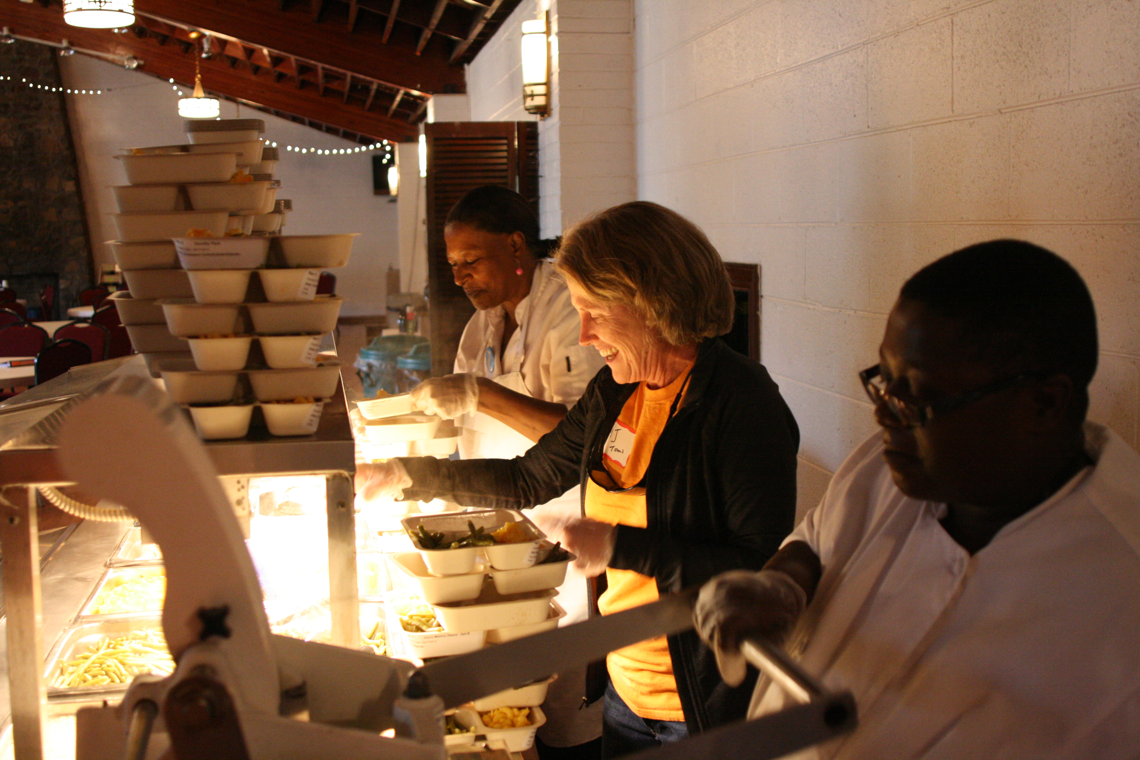 Mary-Jo Toms serves food along side two UVA food workers