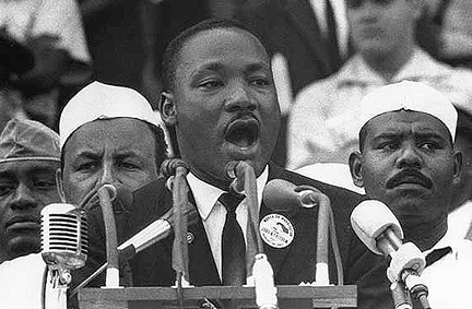 Rev. Dr. Martin Luther King Jr. giving a speech at a podium