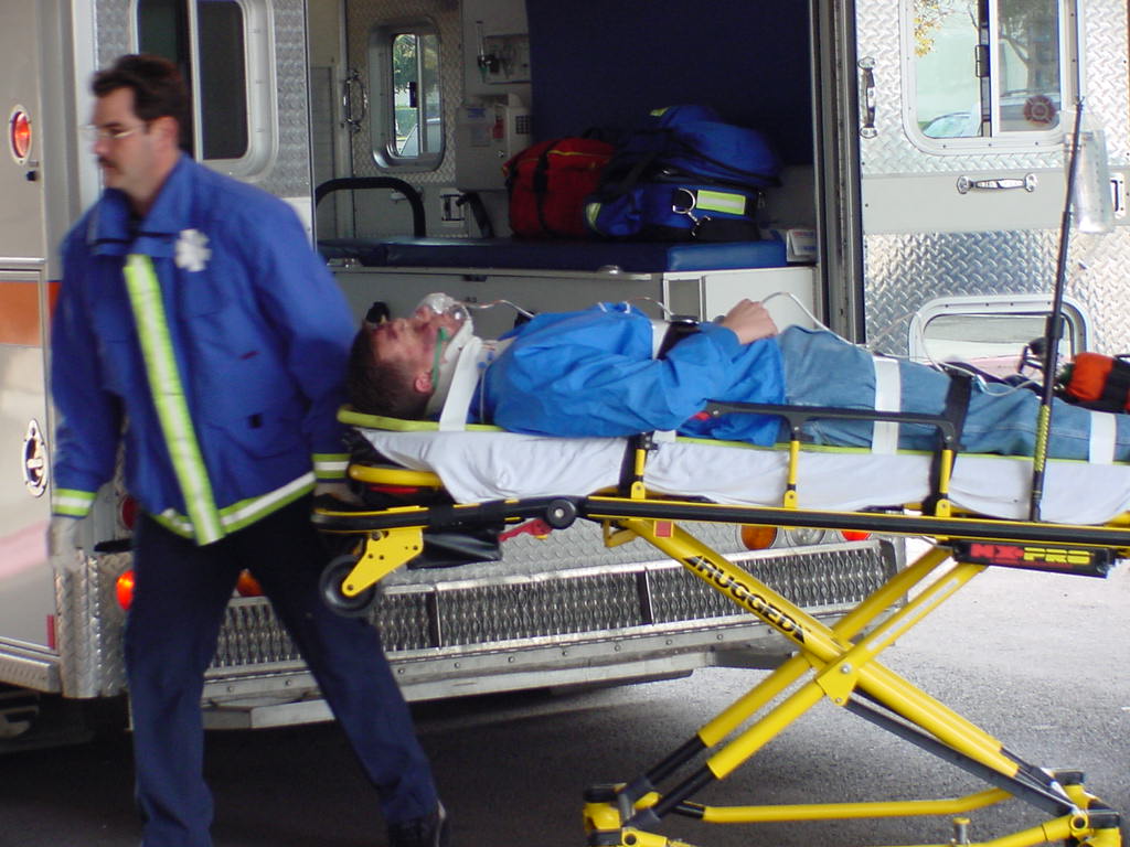 EMT pulling a patient on a stretcher