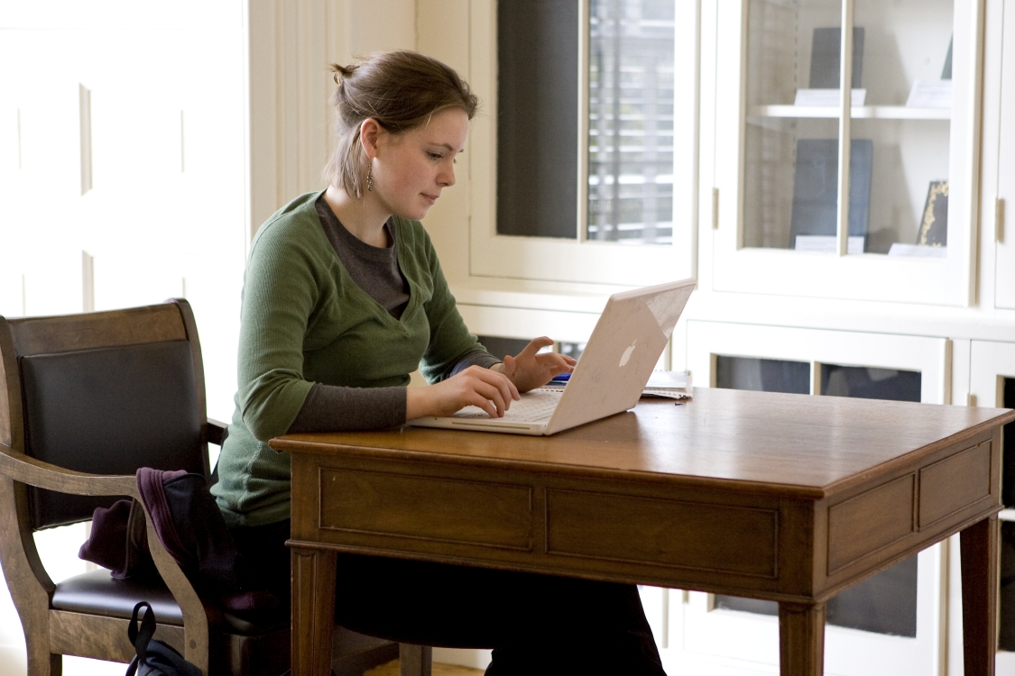 Woman sitting at a desk working on a laptop