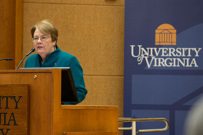President Teresa Sullivan standing at a podium giving a speech